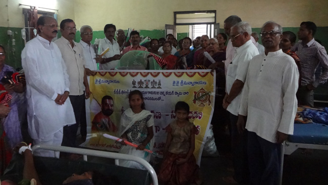 Karimnagar Vikasa Tarangini Distributed Mufflers, Mosquito Protection Umbrellas and Fruits in Govt Civil Hospital