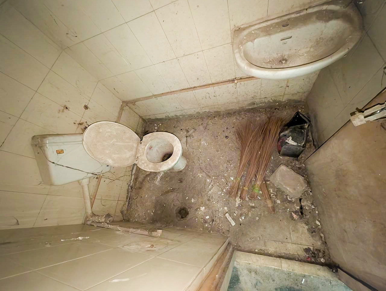 Severely deteriorated hospital washroom before renovation